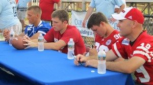 From left: Kickers Drew Farlee, Spencer Lindsay, Brett Maher and Kyle Larson autographed footballs for fans at Community Partners 2012 Annual Fund Campaign Kick-Off event.
