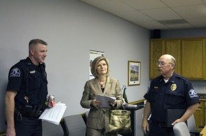 Century 21 Property Manager Alexis McNeal speaks with Chief Lynch and another officer after the meeting.